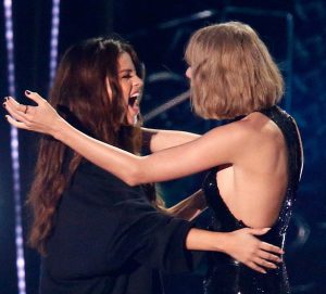 INGLEWOOD, CALIFORNIA - APRIL 03:  Recording artists Selena Gomez (L) and Taylor Swift hug onstage during the iHeartRadio Music Awards at The Forum on April 3, 2016 in Inglewood, California.  (Photo by Rich Polk/Getty Images for iHeartRadio / Turner)