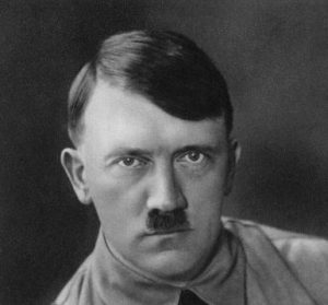 Adolf Hitler, Austrian born dictator of Nazi Germany, 1938. Hitler (1889-1945) became leader of the National Socialist German Workers (Nazi) party in 1921. After an unsuccessful coup attempt in Munich in 1923, for which he was briefly imprisoned, Hitler set about pursuing power by democratic means. His nationalistic and anti-semitic message quickly gained support in a Germany humiliated by defeat in World War I and the harsh terms of the Treaty of Versailles and, from the late 1920s, suffering from economic collapse. Hitler came to power in 1933, and persuaded the Reichstag (parliament) to grant him dictatorial powers. He proceeded to crush opposition both within his own party and throughout German society, and set about re-arming Germany. Hitler's aggressive policy of territorial expansion to secure 'lebensraum' (living space) for the German people eventually plunged the world into the Second World War. A print from Kampf um's Dritte Reich: Historische Bilderfolge, Berlin, 1933. (Photo by The Print Collector/Print Collector/Getty Images)